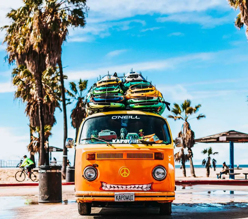 vw van piled high with surfboards