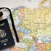 map with passport and camera on top