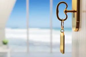 room key danging out of hotel door overlooking ocean