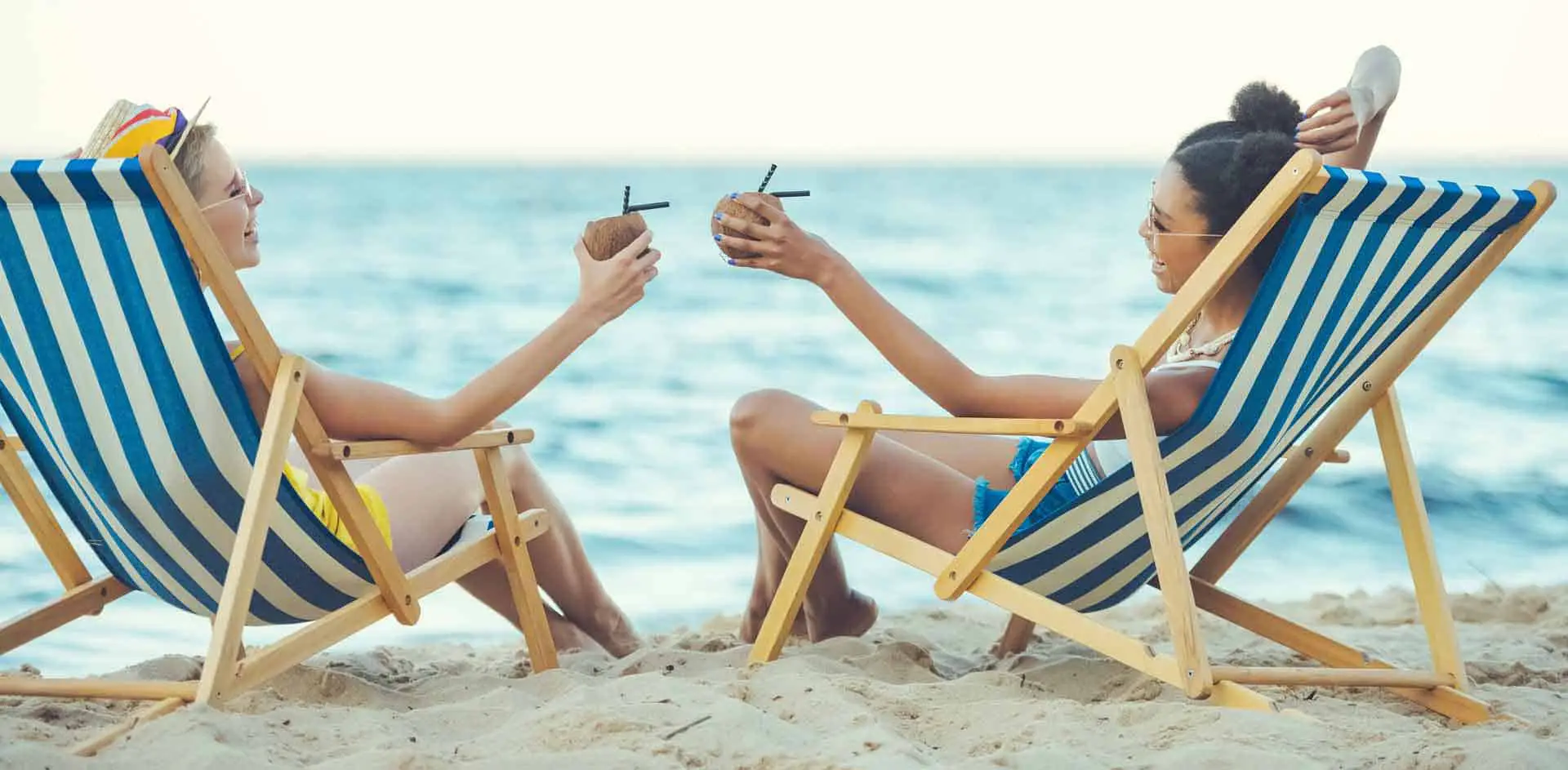 women on the beach enjoying cocktails