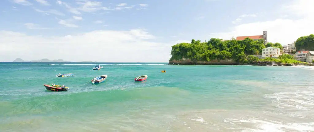 Fishing boats floating around Sauteurs Beach in Grenada