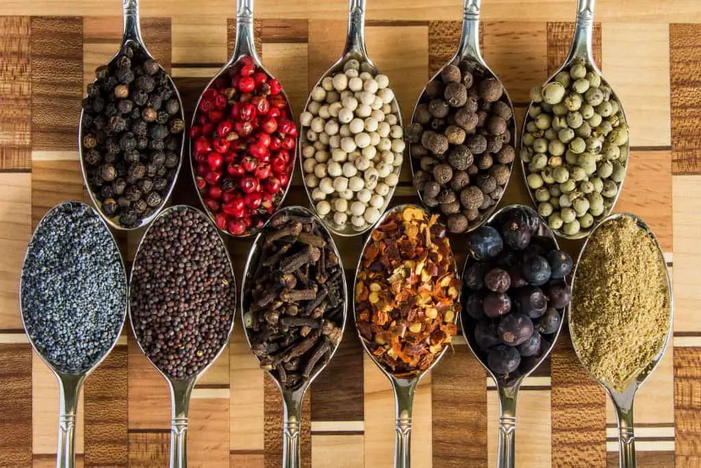 a variety of spices on spoons