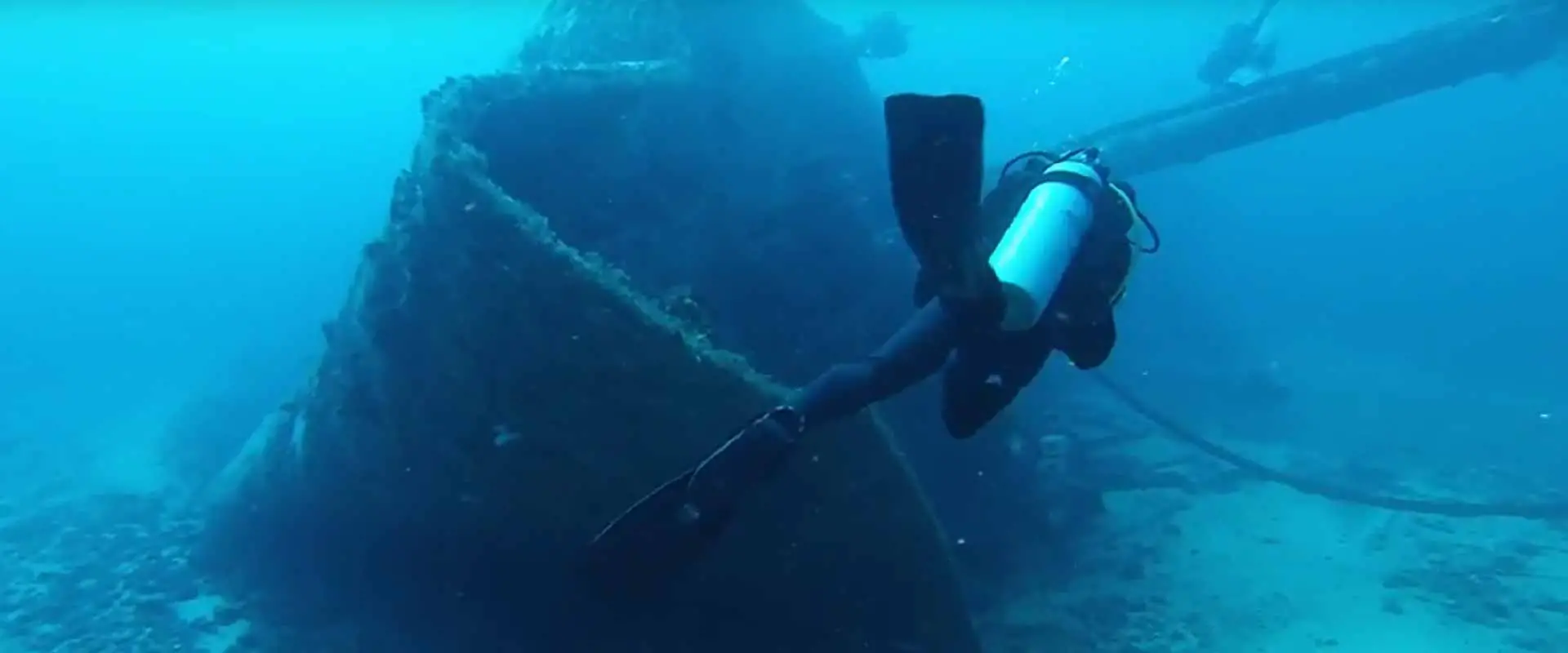 scuba diver swimming around a shipwreck in Grenada